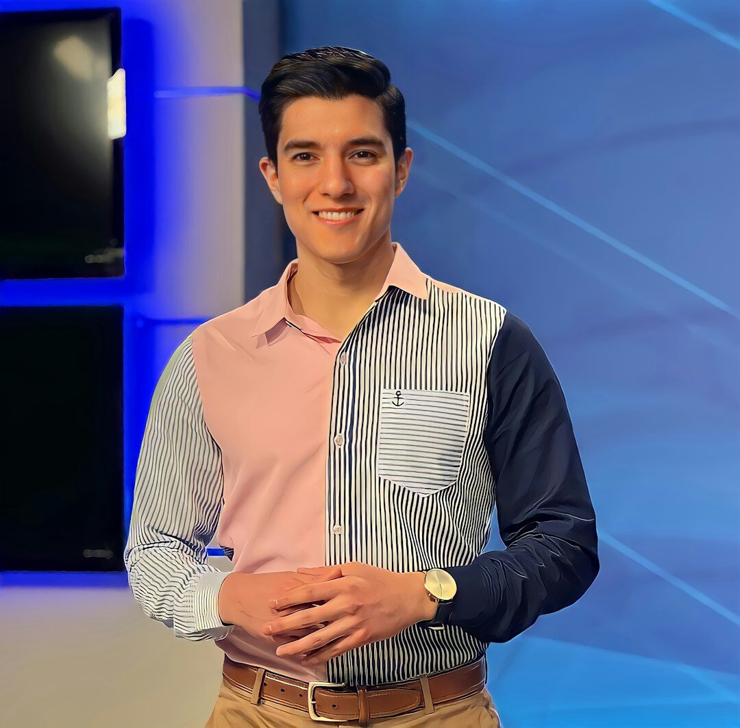 Brazilian male video production instructor smiling professionally